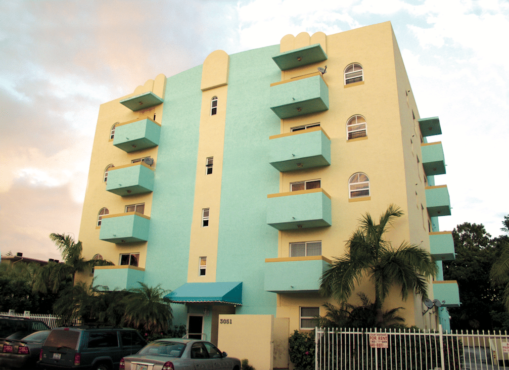 Five story yellow and mint green residential condominium