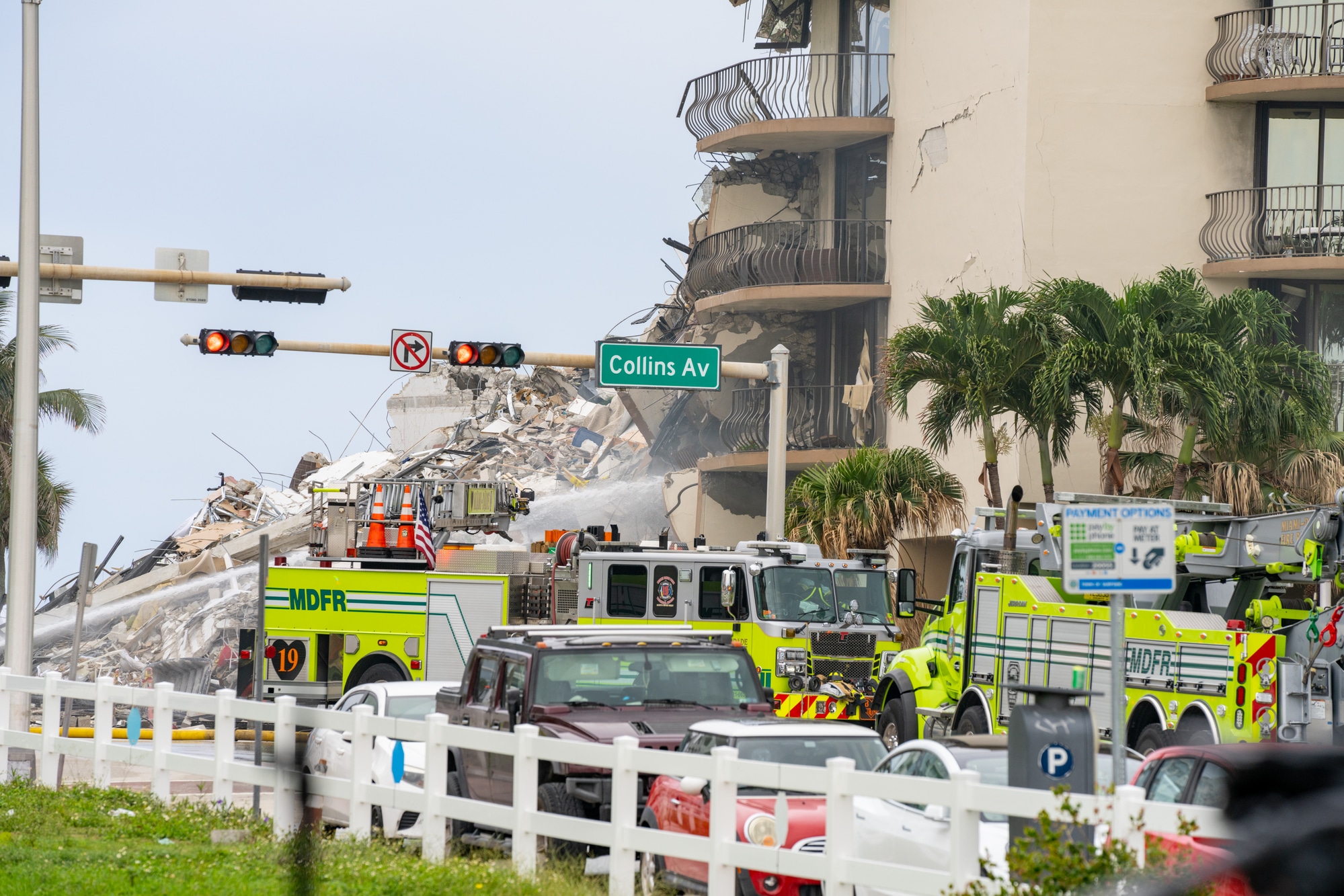 Surfside Condo building collapse with emergency crew trucks